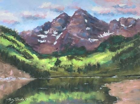 The iconic Maroon Bells near Aspen, Colorado, are reflected in a clear mountain lake in this peaceful pastel painting in lavenders, greens, and maroons by Mary Benke