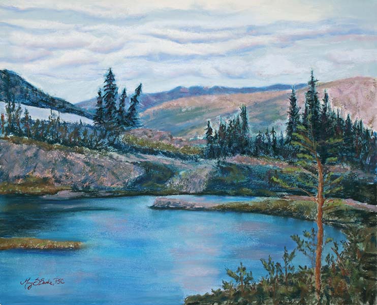 Pastel landscape painting of a high mountain lake with pine trees done in blues, pinks, and greens by Mary Benke