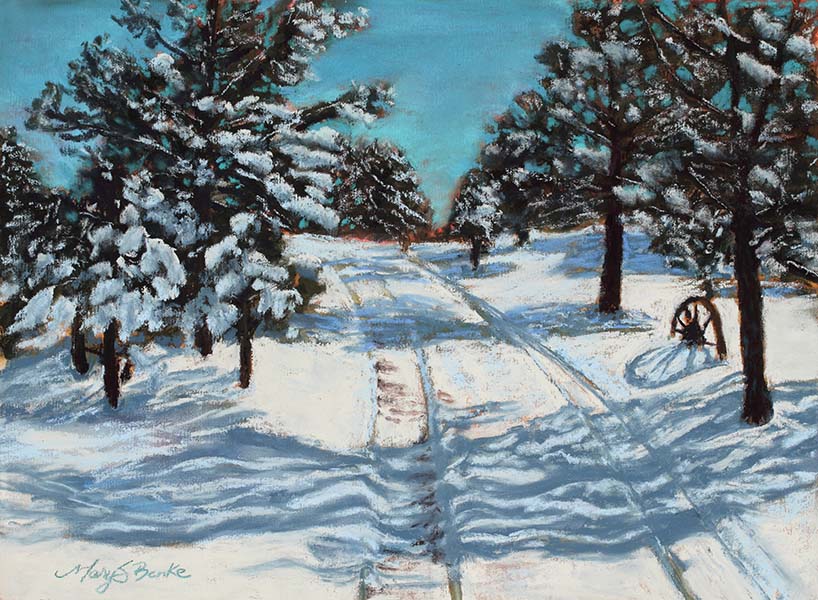 Lights and shadows make interesting patterns on the snow in this rustic winter scene with evergreen trees and a wagon wheel by Mary Benke
