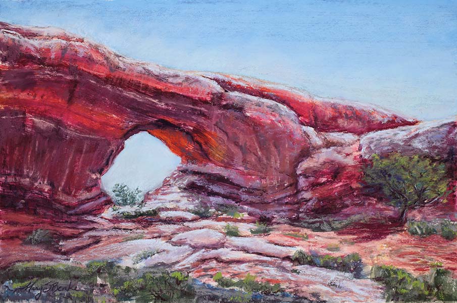 A vivid pastel landscape painting in oranges, reds, and rusts of the North Window rock formation in Arches National Park by Mary Benke